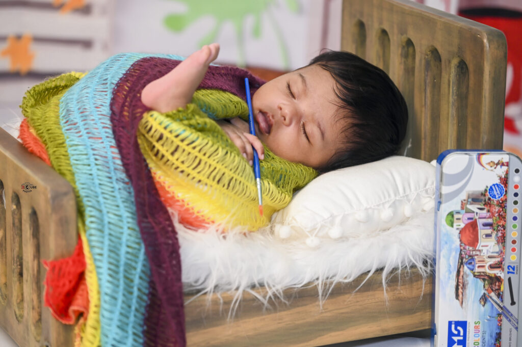 Newborn Artists holding Brush