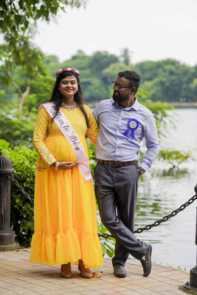 couple pose outdoor maternity